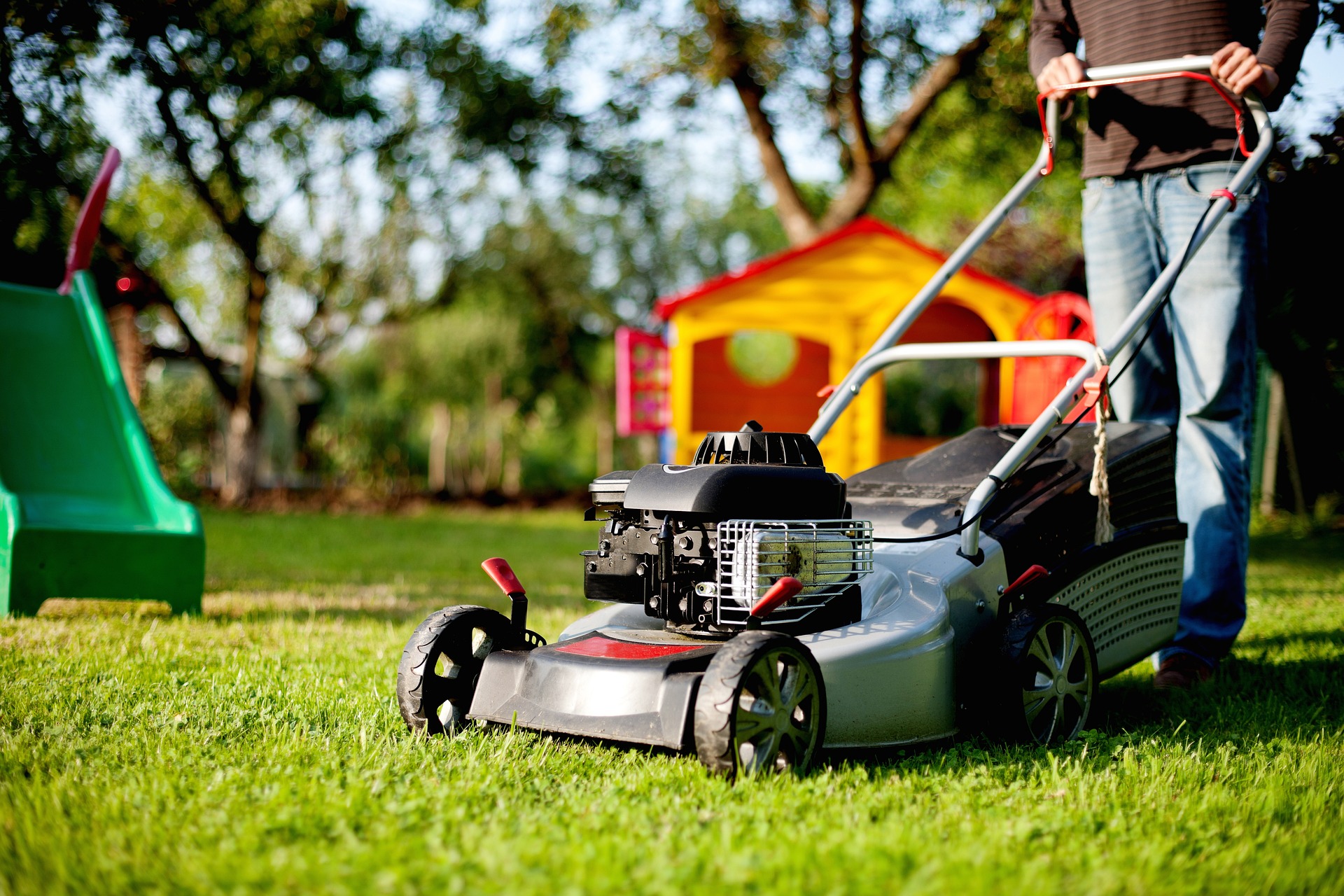 Lawn Mower with playground on the background